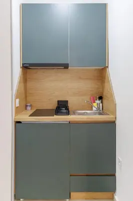 a small kitchen with a sink and a microwave at Apartments Donna in Bar