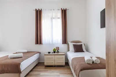 a bedroom with two beds and a window at Apartments Donna in Bar