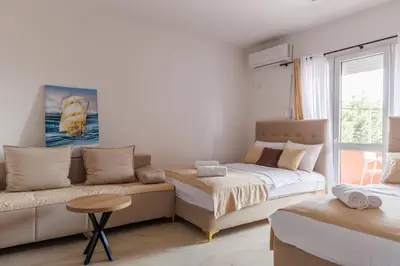 a living room with a bed and a couch at Apartments Donna in Bar