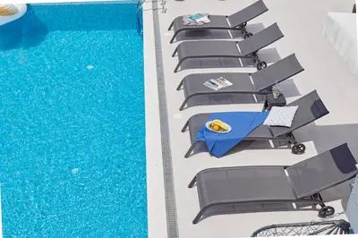 a row of chairs next to a swimming pool at Apartment Kascelan in Kotor