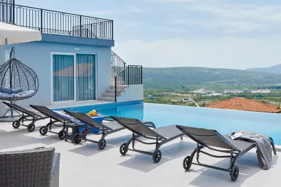 a group of chairs sitting on the roof of a house at Apartment Kascelan in Kotor