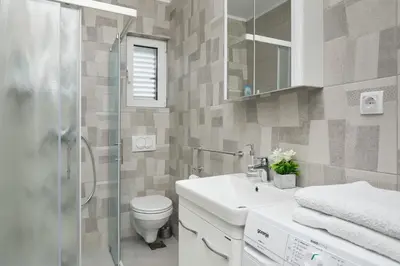 a bathroom with a toilet and a sink and a shower at Apartment Kascelan in Kotor