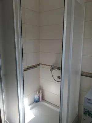 a bathroom with a shower with two bottles of soap at Apartments Mirković in Cetinje