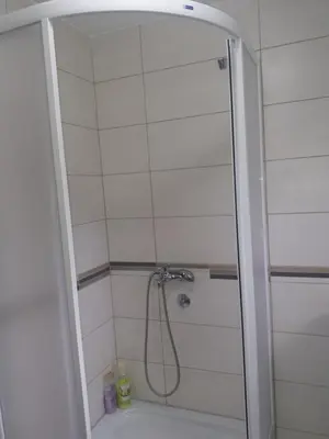 a bathroom with a shower with a tub at Apartments Mirković in Cetinje