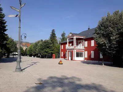 a red building with a street light in front of it at Apartments Mirković in Cetinje