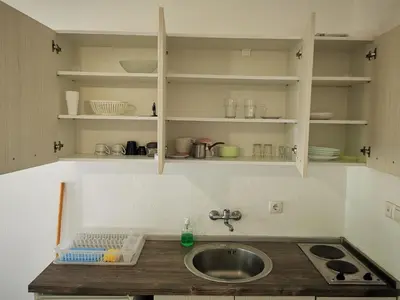 a kitchen with a sink and a counter top at Guest House Levant in Čanj