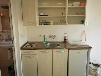 a small kitchen with a sink and a counter at Guest House Levant in Čanj