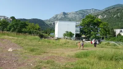 two children walking in a field with mountains in the background at Guest House Levant in Čanj