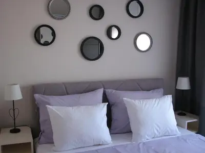 a bedroom with a bed with mirrors on the wall at Apartments B&S Lux in Budva