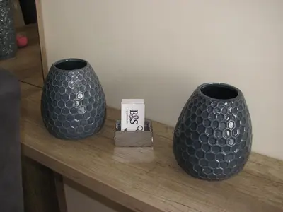 two blue vases sitting on a wooden table at Apartments B&S Lux in Budva