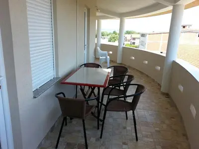 a patio with a table and chairs on a balcony at Apartments Dukat in Ulcinj
