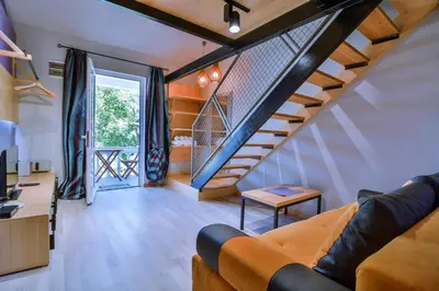 a living room with a staircase and a couch at Jaz Garden Residence in Budva