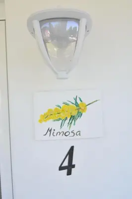 a sign for a wine glass with a bee on it at Jaz Garden Residence in Budva