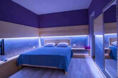 a bedroom with a bed in a purple room at Jaz Garden Residence in Budva