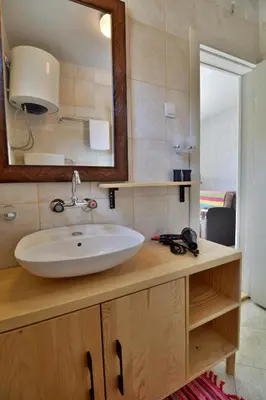 a bathroom with a sink and a mirror at Jaz Garden Residence in Budva