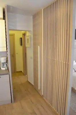 a room with a hallway with wooden floors and yellow walls at Apartmani Art Karampana in Kotor