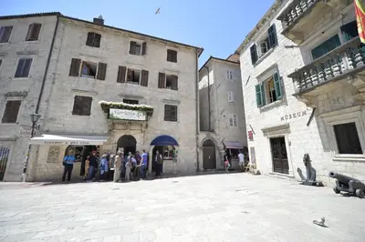 a group of people standing outside of a building at Apartmani Art Karampana in Kotor