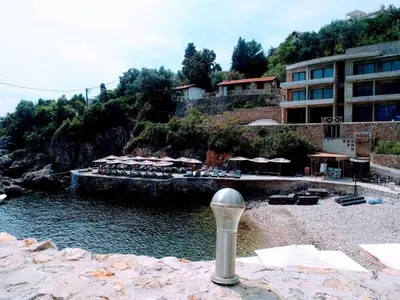 a hotel next to a body of water with a resort at Apartment Spuza in Ulcinj