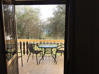 a balcony with a table and chairs on a patio at Apartment Spuza in Ulcinj