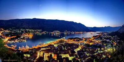 an aerial view of a city with a harbor at night at Apartments House 91 in Kotor