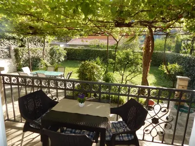 a patio with a table and chairs on a balcony at Apartments House 91 in Kotor