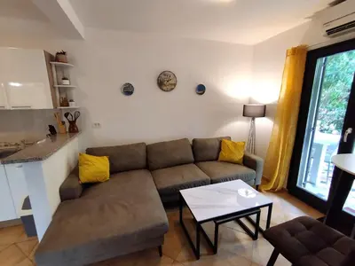 a living room with a couch and a table at Apartments Zezelj in Sveti Stefan