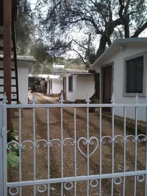 a white fence in front of a house at Raj mira in Utjeha