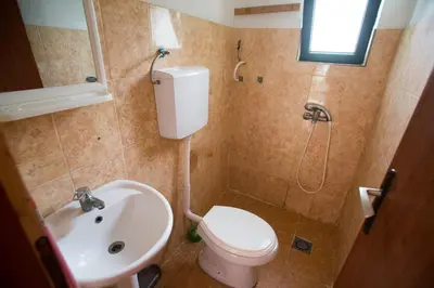 a small bathroom with a toilet and a sink at Raj mira in Utjeha