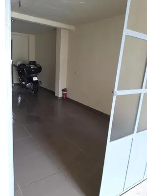 a empty room with a motorcycle parked in it at Kazablanka Rooms Aerodrom in Podgorica