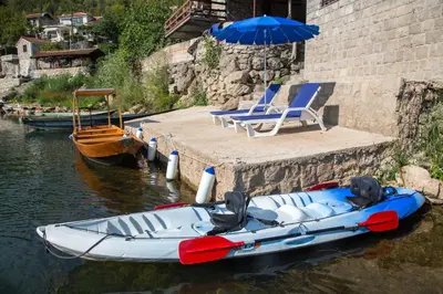 a boat and chairs and an umbrella in the water at 