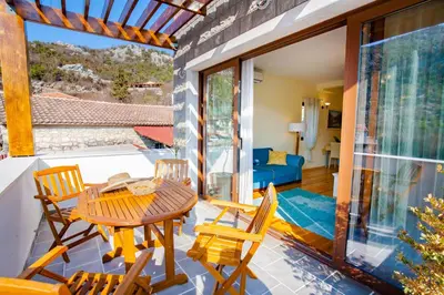 a patio with a table and chairs on a balcony at 