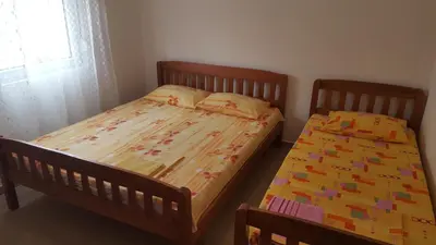 a bedroom with two twin beds and a window at Apartments Diva in Dobra Voda