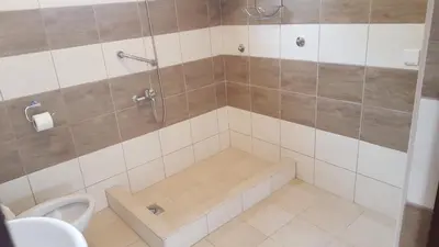 a bathroom with a shower with a tub and a toilet at Apartments Diva in Dobra Voda