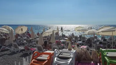 a bunch of chairs and umbrellas on a beach at Apartments Diva in Dobra Voda