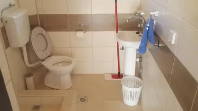 a small bathroom with a toilet and a sink at Apartments Diva in Dobra Voda