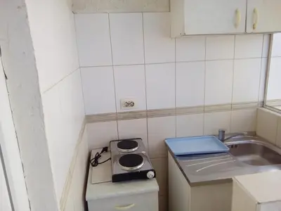 a small kitchen with a sink and a stove at Apartmani Pikula in Sutomore