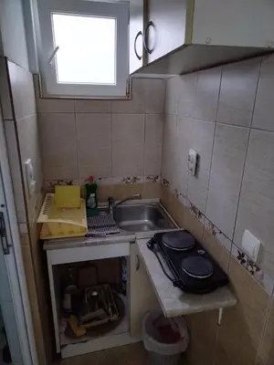 a small kitchen with a sink and a window at Apartmani Pikula in Sutomore