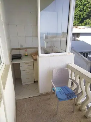 a small kitchen with a chair and a window at Apartmani Pikula in Sutomore
