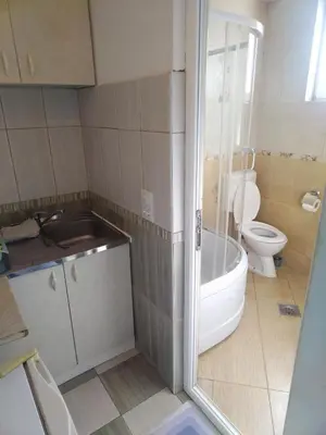 a bathroom with a toilet and a tub and a sink at Apartmani Pikula in Sutomore