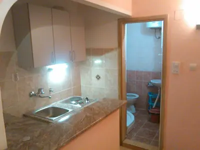 a small bathroom with a sink and a toilet at Apartmani Pikula in Sutomore