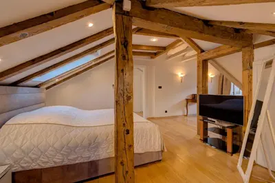 a bedroom with a bed and a flat screen tv at Kotor old town Palace Bucha in Kotor