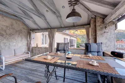 a room with a table and chairs and a couch at Kotor old town Palace Bucha in Kotor