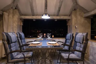 a table and chairs in a room with a window at Kotor old town Palace Bucha in Kotor