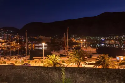 a view of a harbor at night with a city at Kotor old town Palace Bucha in Kotor