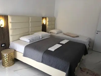 two beds in a hotel room with two beds sidx sidx sidx at Rejhan TOTTI in Ulcinj