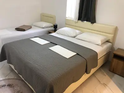 two beds in a hotel room with two at Rejhan TOTTI in Ulcinj
