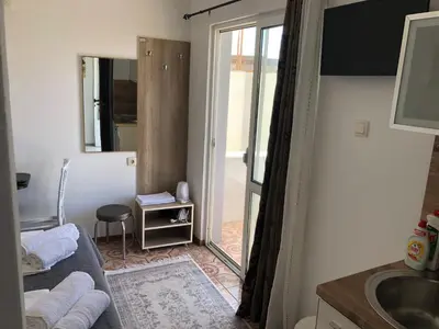 a room with a bathroom with a sink and a mirror at Rejhan TOTTI in Ulcinj
