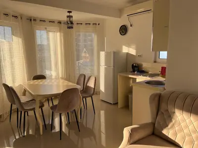 a kitchen and a table and chairs in a kitchen at Rejhan TOTTI in Ulcinj