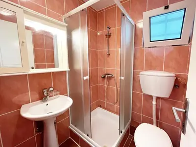 a bathroom with a toilet sink and a shower at Apartmani Novkovic in Bar