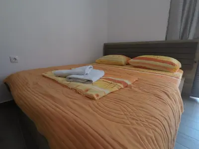 a bed with two towels and two pillows on it at Hostel Center in Ulcinj